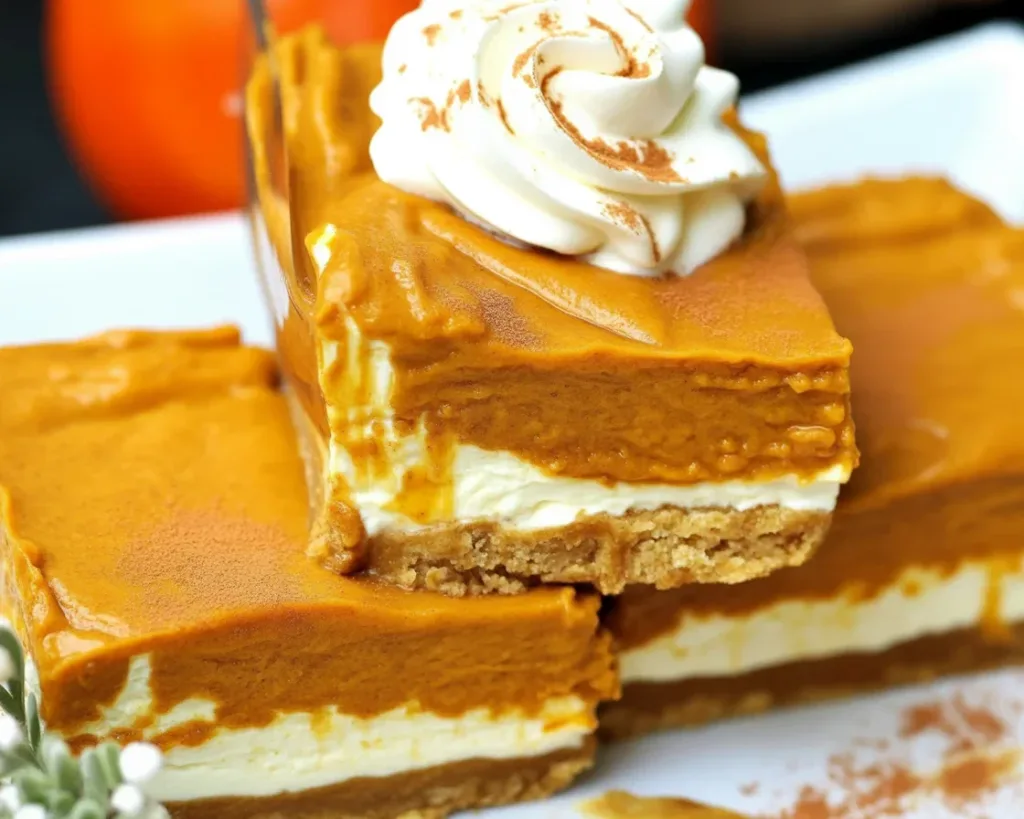 Delicious Keto pumpkin cheesecake bars with almond crust and pumpkin spice.